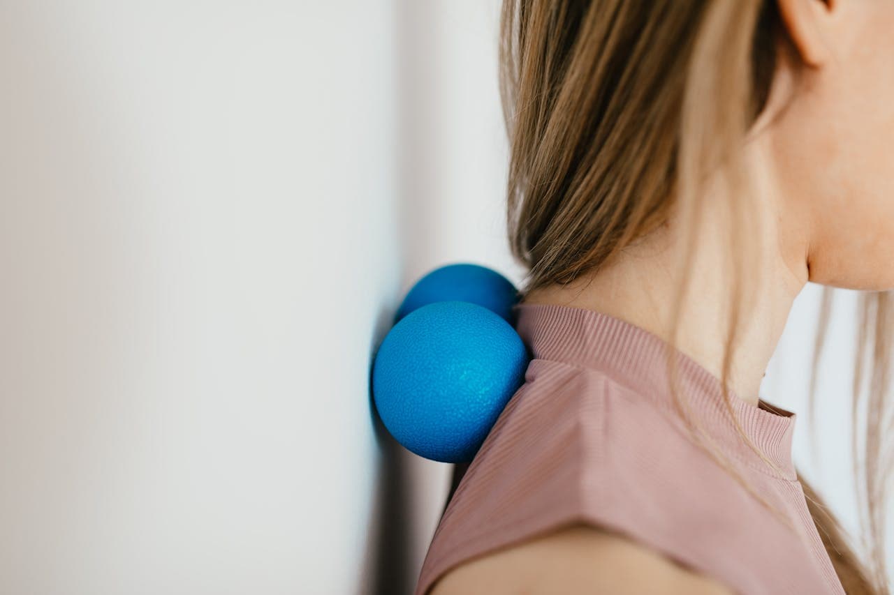 Desk worker rubbing their neck due to pain from long hours at a computer.